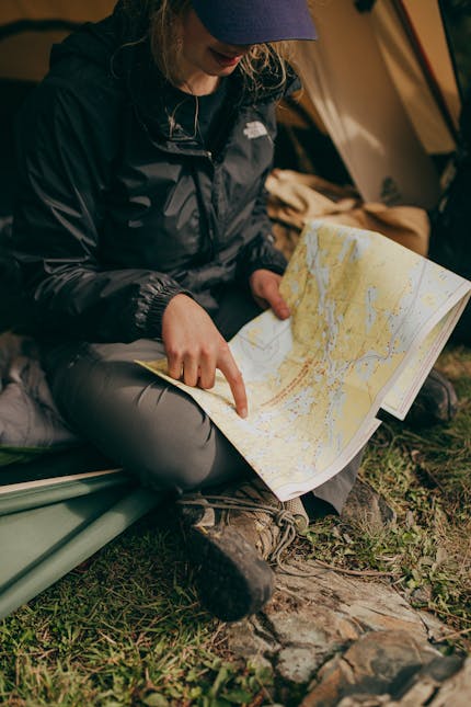 Essential Hiking Gear For Beginners - Man Reading a map