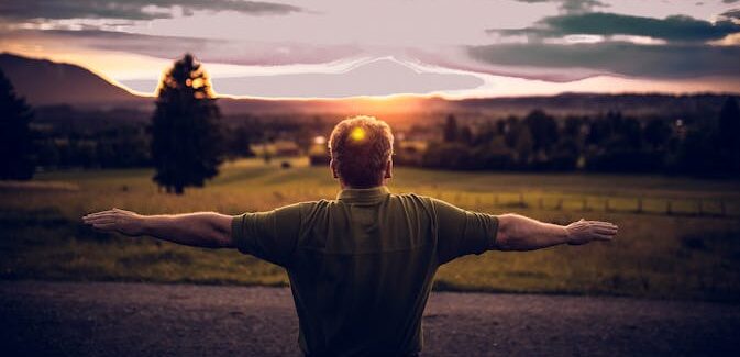 Should You Stretch After Hiking - Man stretching in the bush