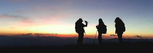 How To Stay Hydrated On A Hike - Silhouette of hiker drinking water