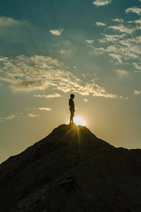 How To Hike Uphill Efficiently Without Getting Tired - Hiker on a peak.