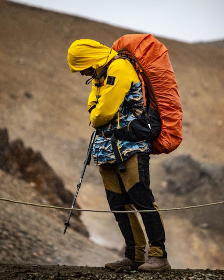 Hiking In The Rain Guide - hiker with a covered backpack