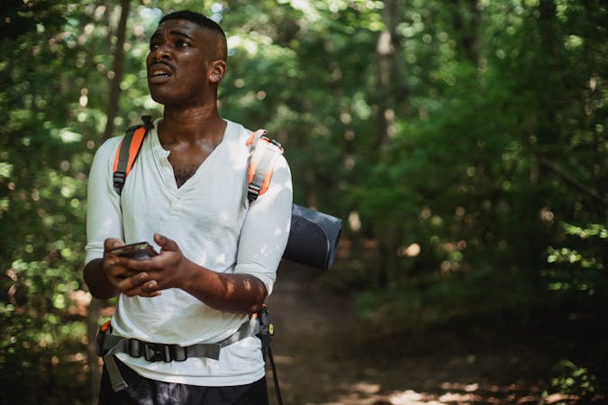 Hiking Errors To Avoid - Hiker with a cell phone